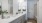 A bathroom with glass shower and vanity 